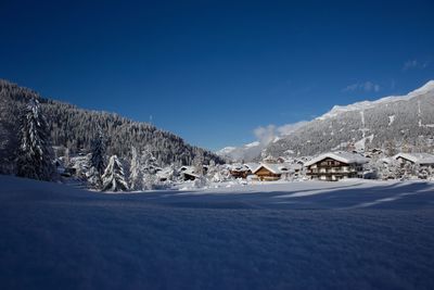 Scenic view of snowcapped mountains against clear blue sky