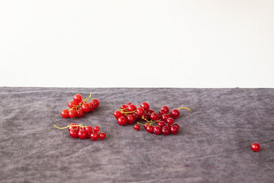 Close-up of red cherries against white background