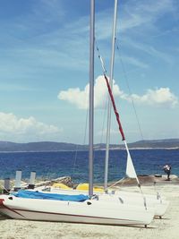 Sailboats on beach against sky