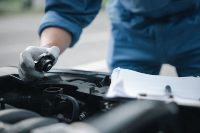 Midsection of man repairing car