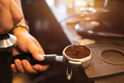 Worker works with a coffee machine