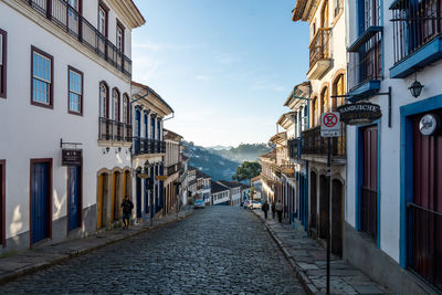 Empty alley amidst buildings in city