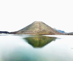 Scenic view of lake and mountains against clear sky