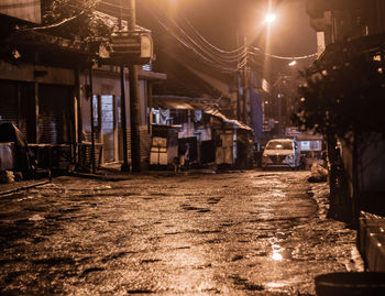 Street amidst illuminated city at night