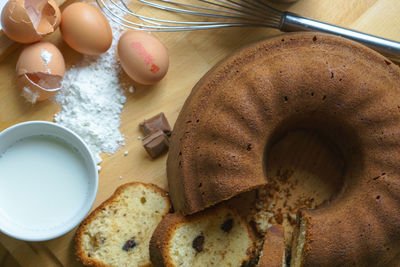 High angle view of cakes and eggs on table in kitchen at home