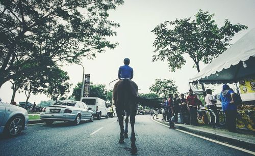 Rear view of man walking on road