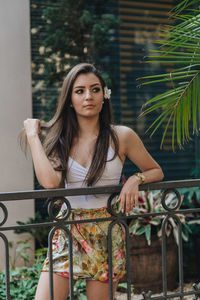 Portrait of a young woman sitting outdoors
