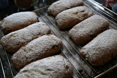 Close-up of pastry items with powdered sugar on baking sheet