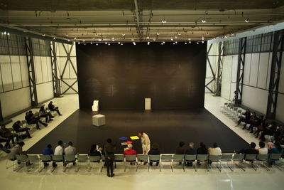 High angle view of people sitting on chair for seminar