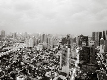 High angle view of modern buildings in city against sky