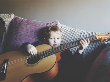 Portrait of boy playing guitar