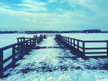 Pier over sea against sky