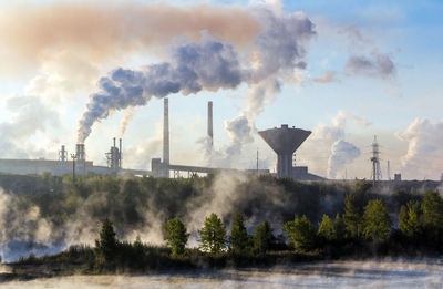 Panoramic view of smoke stack against sky