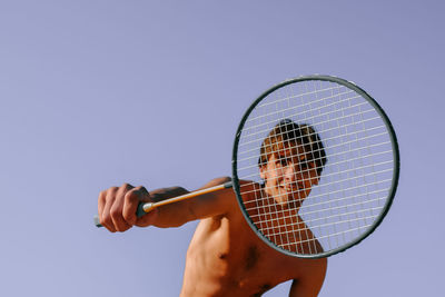 Portrait of man holding tennis racket