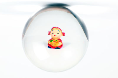 Close-up of toy figurine against white background