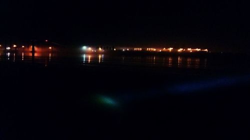 Reflection of illuminated sky on water at night