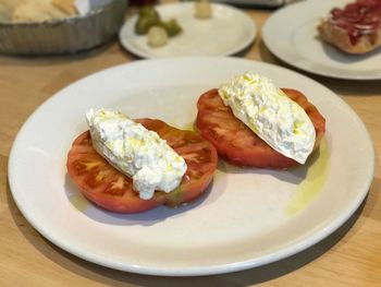 Close-up of egg on tomatoes in table