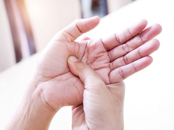 Cropped image of person holding aching hand