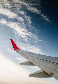 Close-up of airplane wing against sky