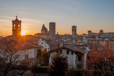 Buildings in city at sunset