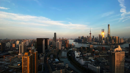 Aerial view of modern buildings in city against sky