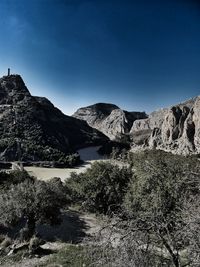 Scenic view of mountains against clear blue sky