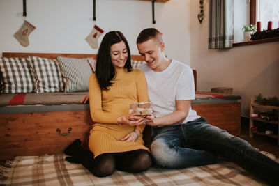 Young couple sitting at home