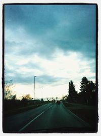 Road passing through dramatic sky