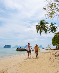 People on beach against sky