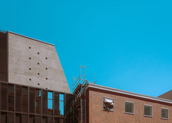 Low angle view of building against clear blue sky