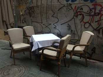 Empty chairs and table in abandoned room