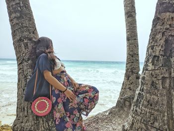 People at beach against sky