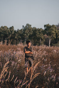 Man standing on field against sky