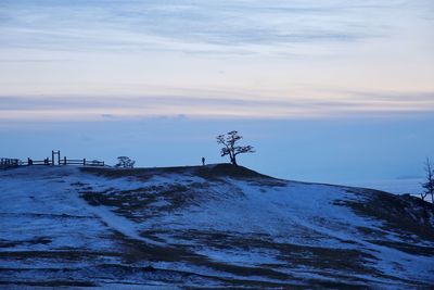 Scenic view of snow covered land during sunset