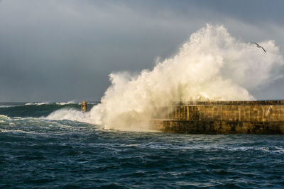 Waves breaking against pier