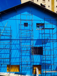 Low angle view of modern building against blue sky