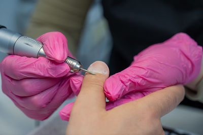 Midsection of man holding thermometer