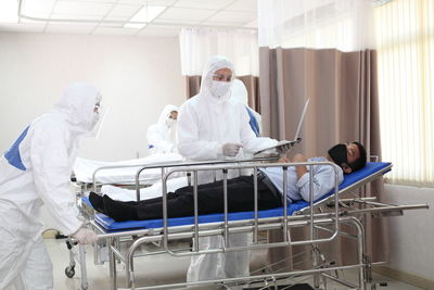 Doctors by patient in hospital