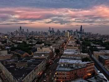 High angle view of cityscape against cloudy sky