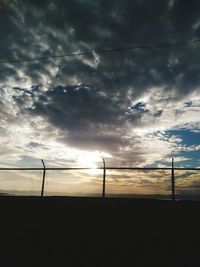 Scenic view of field against cloudy sky