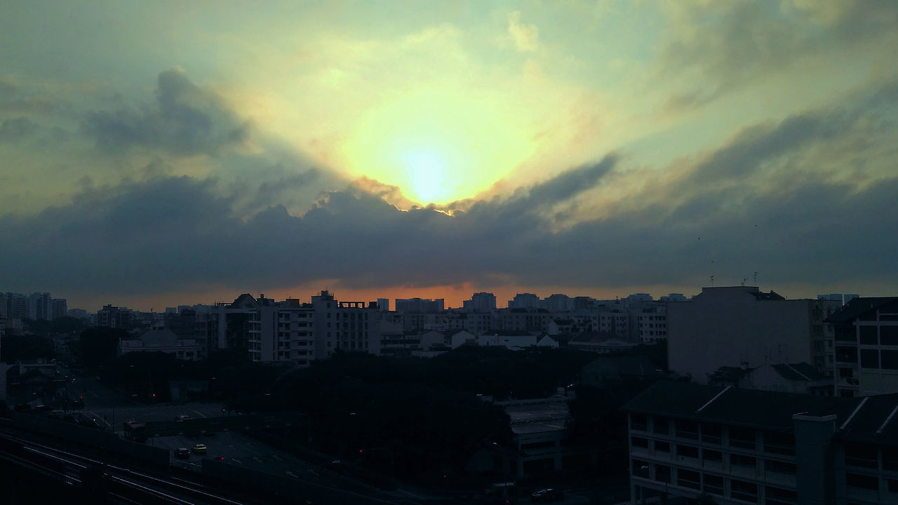 VIEW OF CITY AGAINST DRAMATIC SKY