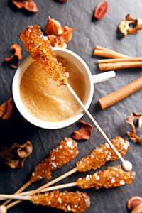 View of coffee cup and sugar sticks