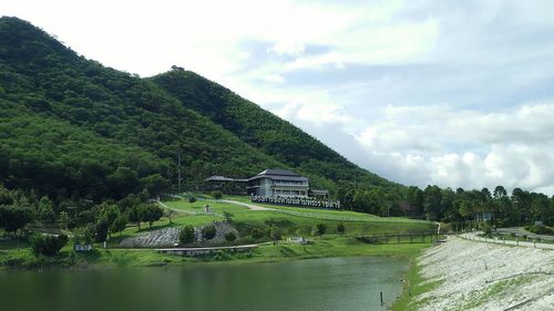 Scenic view of river by trees against sky