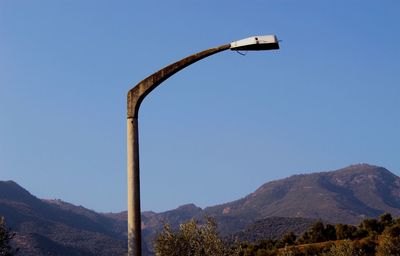 Low angle view of street light against clear blue sky