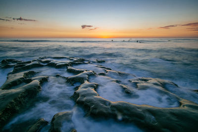 Scenic view of sea against sky at sunset