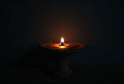 Close-up of illuminated lamp against black background