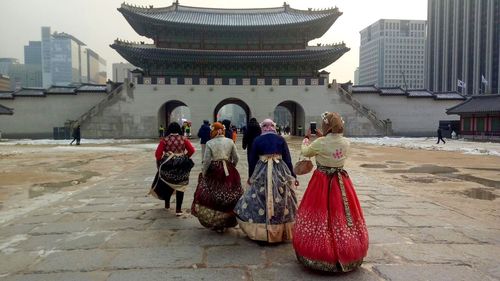 Rear view of people walking in a building