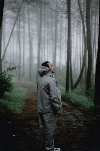 Rear view of man standing in forest