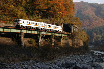 View of local train passing through bridge in the morning sun