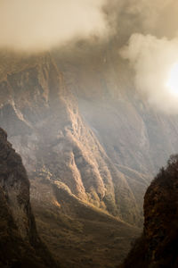 Scenic view of mountains with clouds against sky